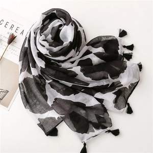 Lightweight black floral cotton scarf with tassel fringe edges and artistic pattern