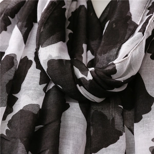 Detail of black and white floral print scarf showing soft texture and lightweight fabric