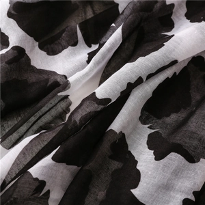 Macro shot of breathable leopard print voile fabric with soft drapes and sheer texture