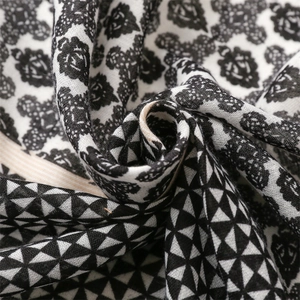 Macro view of cotton-linen feel scarf showing geometric patterns and floral motifs