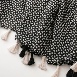 Macro shot of geometric black and white scarf with soft cotton-linen fringe detail