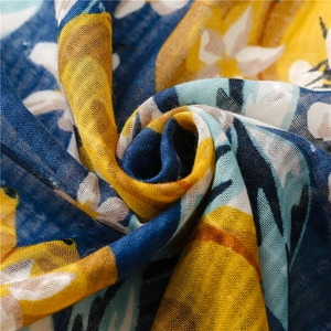 Macro detail of breathable cotton-linen scarf fabric with yellow floral print and texture