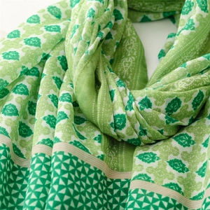 Detail of green leaf and geometric pattern on lightweight linen-feel scarf