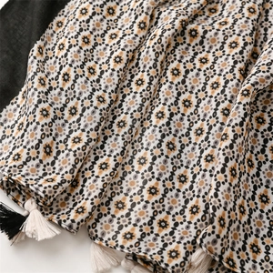 Detailed view of bohemian floral print scarf with soft fringe tassels and geometric patterns