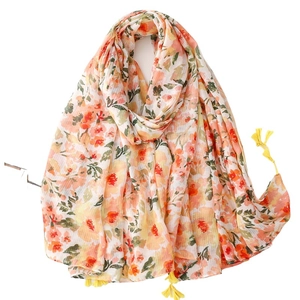 Lightweight cotton-linen floral scarf with bright yellow tassels for a fresh summer look