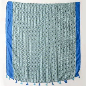 Macro detail of blue floral cotton linen scarf featuring mandala patterns and soft tassels