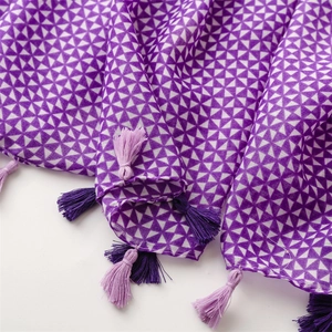 Detailed macro view of geometric purple floral pattern scarf with soft fringe edges