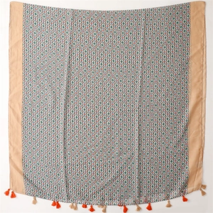 Detail of printed cotton linen scarf featuring geometric dot patterns and orange tassels