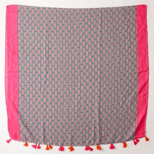 Detail of floral linen scarf featuring magenta borders and colorful tassel fringe trim