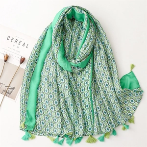 Close-up of lightweight green floral cotton linen scarf with elegant fringe details