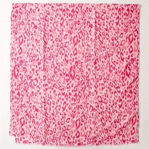 Detail of pink leopard print scarf fabric texture and delicate frayed fringe edges