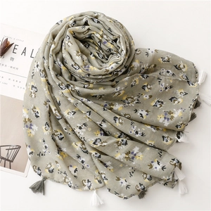 Detailed view of floral pattern and fringe tassels on a breathable cotton linen scarf