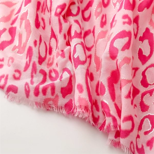 Detailed view of pink leopard print scarf with metallic foil edges and soft fringe