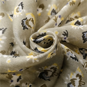 Macro detail of soft green floral pattern on lightweight cotton linen blend scarf fabric