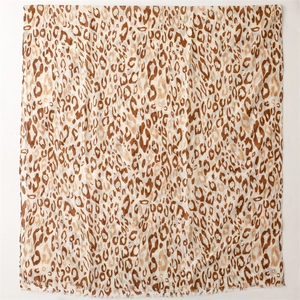 Close-up of leopard print scarf featuring soft frayed edges and breathable linen texture