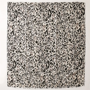 Close-up of leopard print scarf with fine fringe edges and soft linen-feel fabric texture