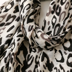 Detail of leopard print scarf with silver glitter threads and soft textured fraying edges