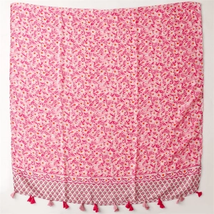 Detail of pink floral cotton-linen scarf with soft tassels and elegant border patterns