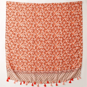 Detail view of floral cotton linen shawl featuring red tassels and ethnic patterns
