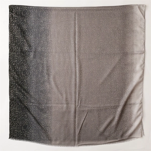 Detail of gradient pashmina shawl with shimmering sequins and frayed edge texture