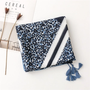 Detail of blue geometric leopard print scarf with tassels and soft cotton-linen texture