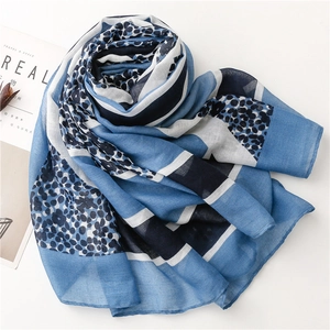 Detail of blue geometric leopard print scarf with light cotton-linen feel and stylish patterns