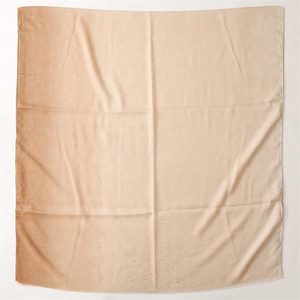 Detail of linen-feel scarf featuring gold foil gradient and subtle frayed edges texture