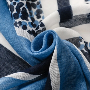 Close-up of lightweight blue geometric leopard print scarf with woven linen texture