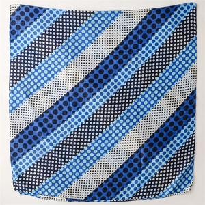 Detail shot of lightweight cotton-linen feel scarf with blue polka dots and stripes