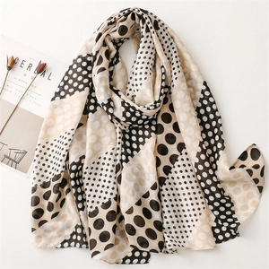French style beige and black polka dot scarf with frayed edges in a minimalist setting