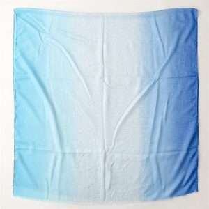Detail of blue gradient cotton linen scarf with sparkling gold foil and frayed edges