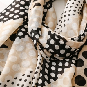 Detail of soft cotton-linen feel scarf with classic polka dots and fine stitched edges
