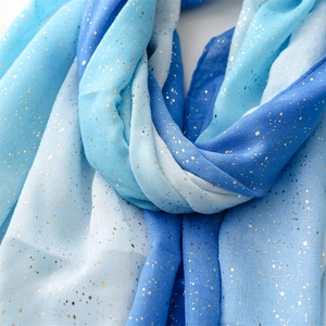 Detailed view of blue gradient shawl with golden foil dots and soft texture