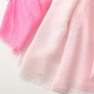 Detail of pink cotton-linen scarf featuring gold foil dots and raw fringe edges