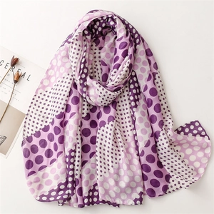 Purple and white polka dot lightweight scarf with frayed edges displayed on white surface