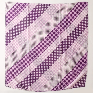 Detail of soft purple and white polka dot scarf with diagonal striped pattern and texture