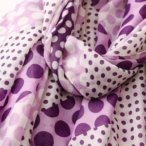 Close-up of soft purple and white polka dot pattern on lightweight cotton linen scarf