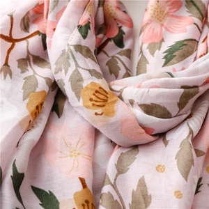 Close-up of pink bohemian floral pattern on breathable linen fabric for beach scarves