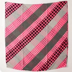 Detailed pattern of a square scarf with pink and black stripes and polka dots