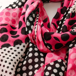 Detail of lightweight cotton-linen scarf showing vibrant polka dot patterns and soft stitching