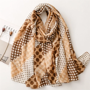 Detailed flat lay of a lightweight polka dot scarf with diagonal color block patterns