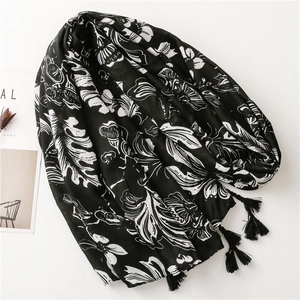 Detail of vintage ethnic floral shawl with black tassels and light breathable fabric