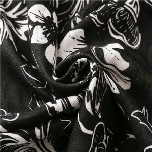 Close-up of black and white floral printed twill fabric with soft textile texture