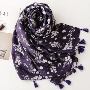Detail of dark purple floral beach shawl with delicate fringe tassels and lightweight fabric
