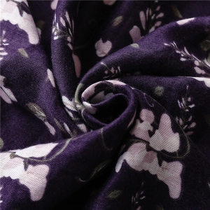 Detailed close-up of dark purple beach shawl with delicate floral print and soft drape