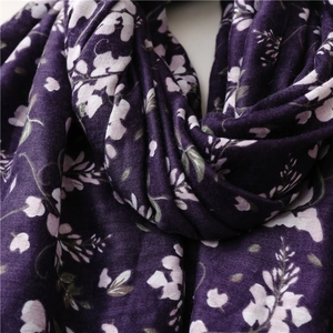Detail of soft purple floral chiffon shawl with elegant white flower prints and draping texture