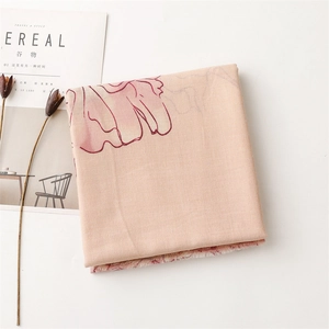 Detail of nude pink floral cotton linen scarf with frayed edges and artful printing
