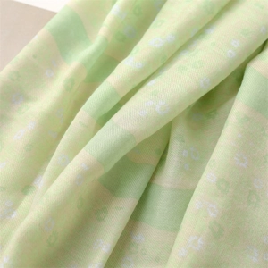 Detail of soft linen-feel scarf fabric with blue floral print and striped pattern texture