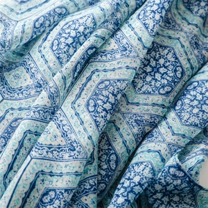 Detail shot of ethnic blue geometric print and soft cotton-linen texture of the shawl