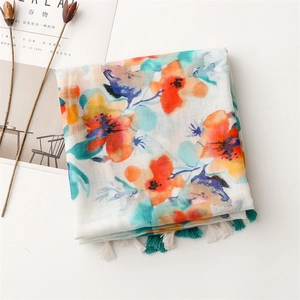 Detailed view of floral watercolor scarf with colorful patterns and woven fringe tassels